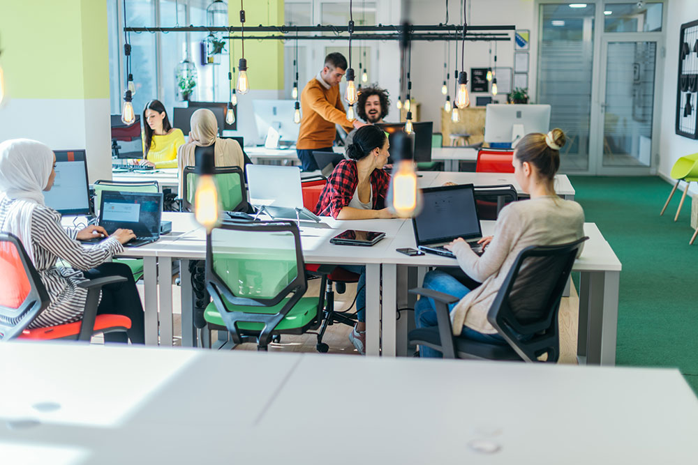 An open-plan Linkly office with colleagues at their desks