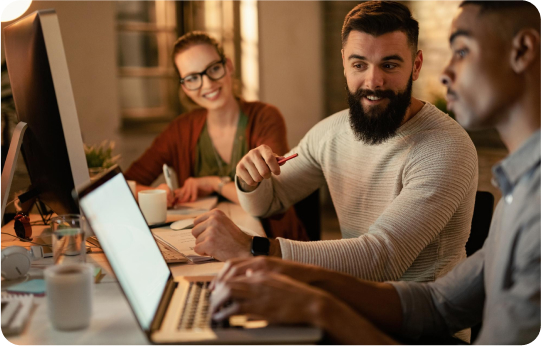 Three Linkly colleagues working together at a desk