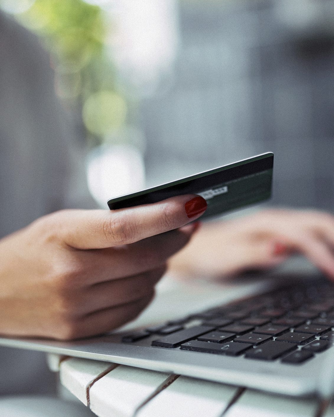 A customer entering card details on a laptop